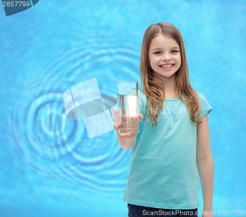 Image of smiling little girl giving glass of water