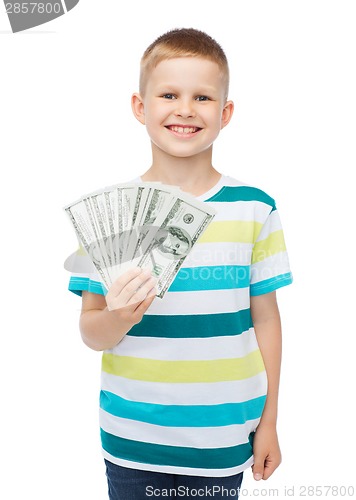 Image of smiling boy holding dollar cash money in his hand