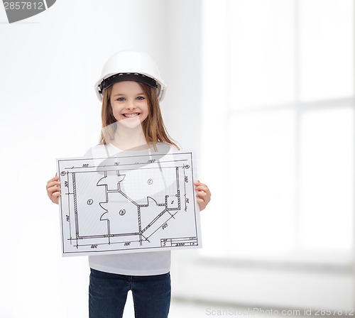 Image of smiling little girl in helmet showing blueprint