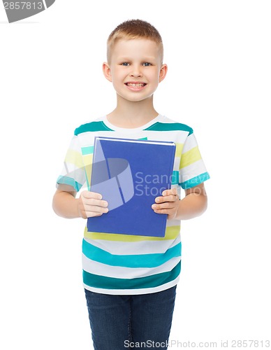 Image of smiling little student boy with blue book