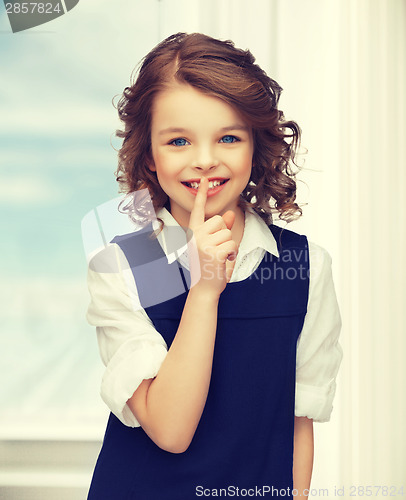 Image of pre-teen girl showing hush gesture