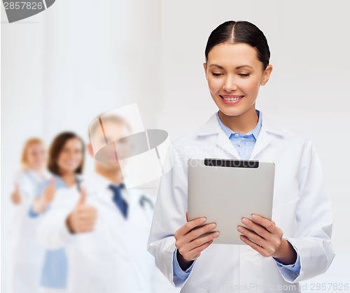 Image of female doctor without stethoscope and tablet pc