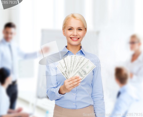 Image of young businesswoman with dollar cash money