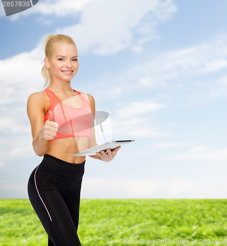 Image of smiling sporty woman with tablet pc computer