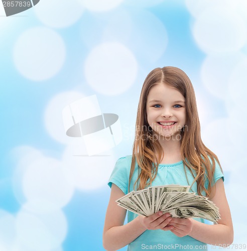 Image of smiling little girl with dollar cash money