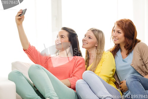 Image of teenage girls taking selfie with smartphone