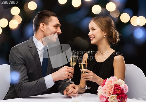 Image of couple with glasses of champagne at restaurant