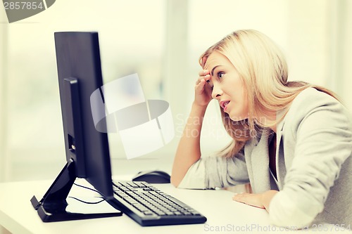 Image of stressed woman with computer