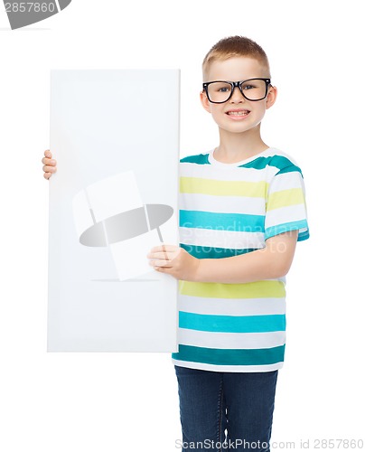 Image of smiling boy in eyeglasses with white blank board