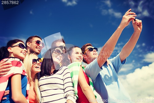 Image of group of friends taking picture with smartphone