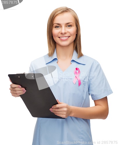 Image of smiling female doctor or nurse with clipboard