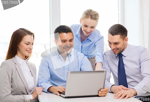 Image of business team working with laptop in office