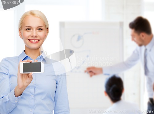 Image of smiling businesswoman with smartphone blank screen