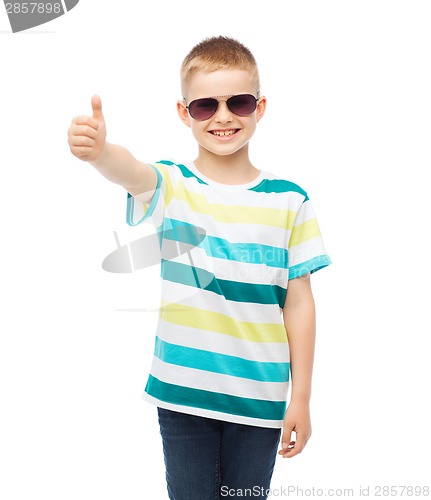 Image of smiling little boy in sunglasses showing thumbs up