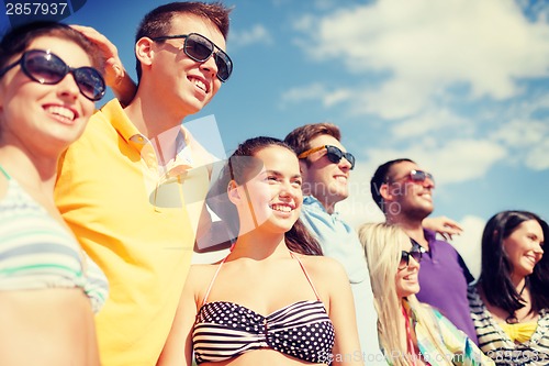 Image of group of friends having fun on the beach