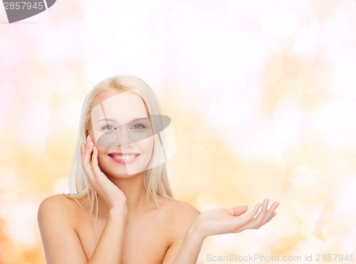 Image of smiling woman holding imaginary lotion jar