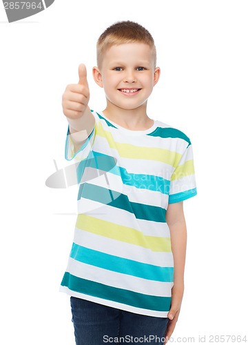 Image of little boy in casual clothes showing thumbs up