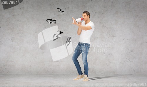 Image of handsome man with megaphone over concrete wall