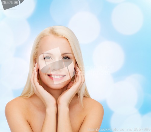Image of beautiful woman touching her face skin