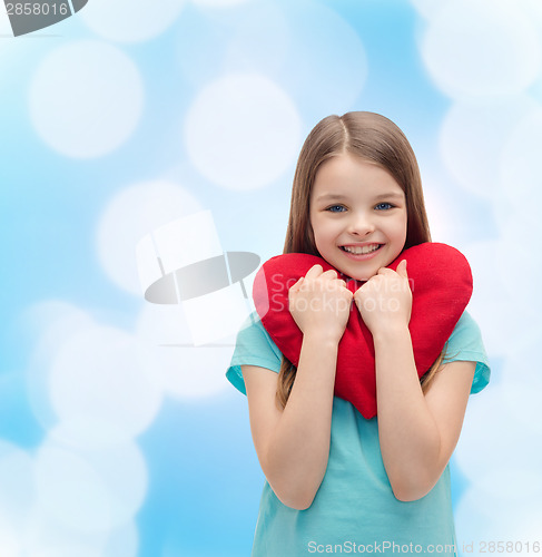 Image of smiling little girl with red heart