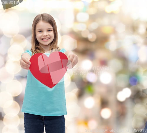 Image of smiling little girl giving red heart