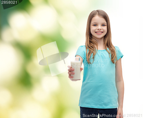 Image of smiling little girl giving glass of milk