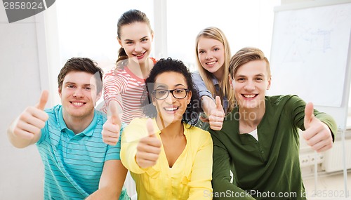 Image of smiling students at school showing thumbs up