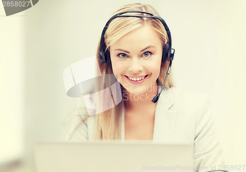 Image of friendly female helpline operator with laptop