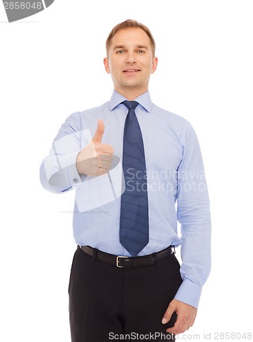 Image of smiling businessman showing thumbs up