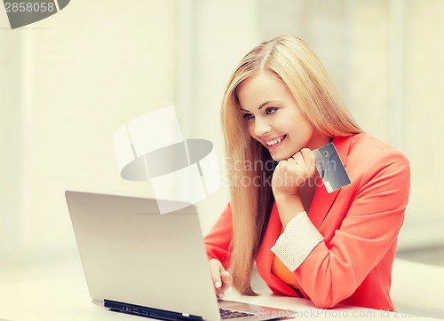 Image of businesswoman with laptop and credit card