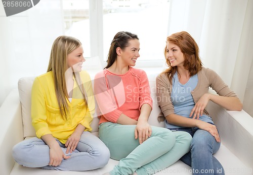 Image of three girlfriends having a talk at home