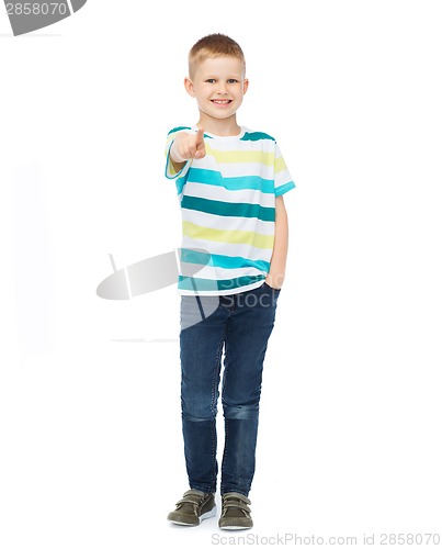 Image of Little boy in casual clothes pointing his finger