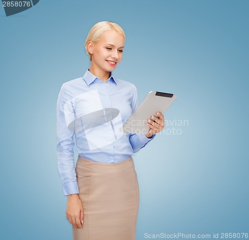Image of smiling woman looking at tablet pc computer