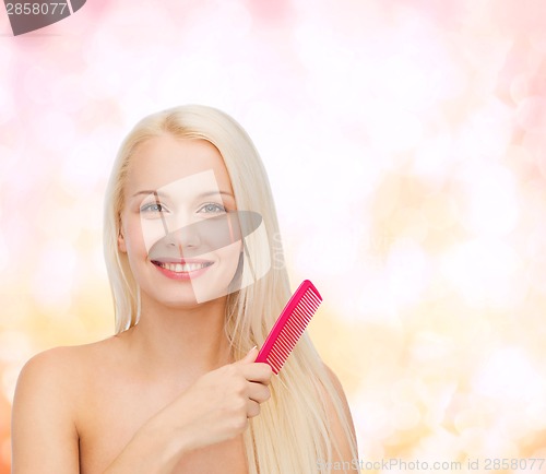 Image of smiling woman with hair brush