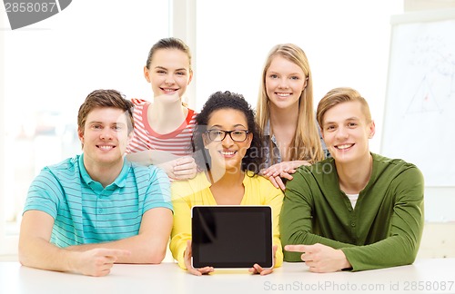 Image of smiling students showing tablet pc blank screen