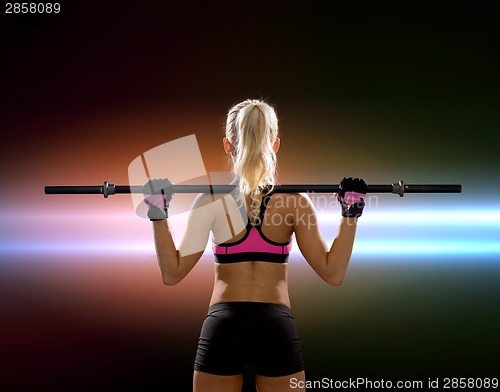 Image of sporty woman exercising with barbell