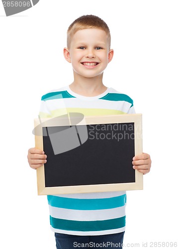Image of smiling little boy holding blank black chalkboard
