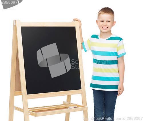 Image of happy little boy with blank blackboard