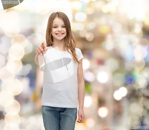 Image of little girl in blank white t-shirt pointing at you