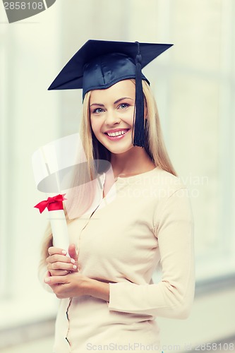 Image of student in graduation cap with certificate