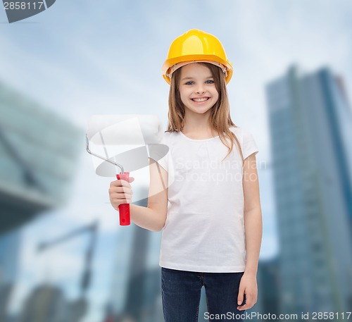 Image of smiling little girl in helmet with paint roller