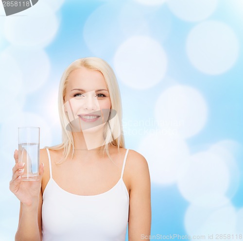 Image of young smiling woman with glass of water