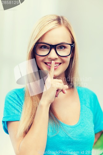 Image of woman with finger on her lips