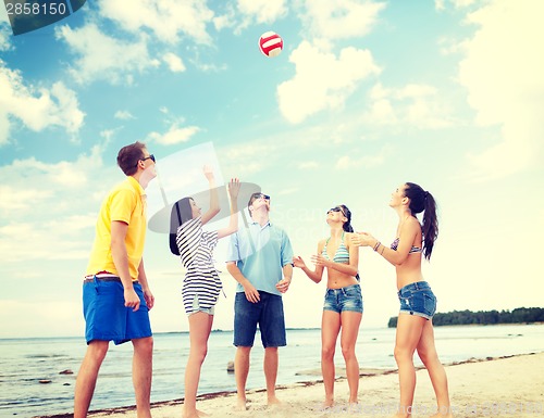 Image of group of friends having fun on the beach