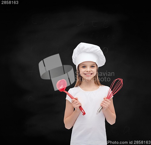 Image of smiling girl in cook hat with ladle and whisk
