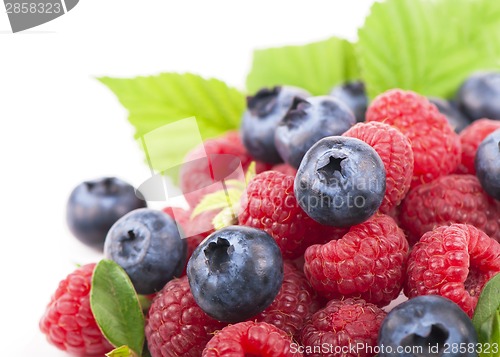 Image of Many blueberries, raspberries. Isolated white