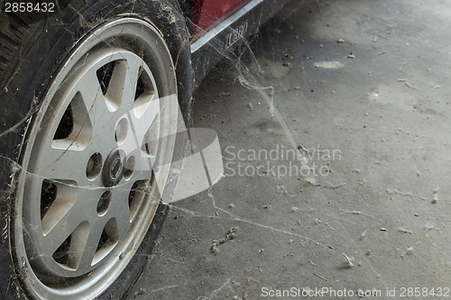 Image of 80’s tire among cobwebs