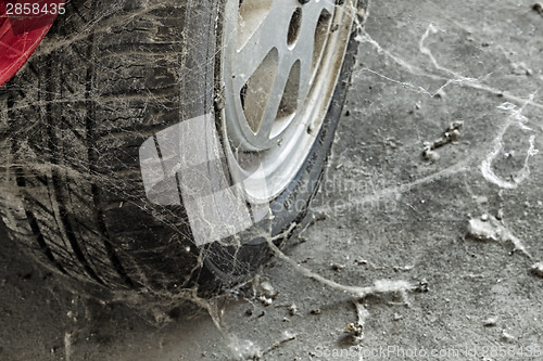 Image of 80’s tire among cobwebs