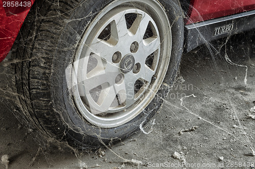 Image of 80’s tire among cobwebs