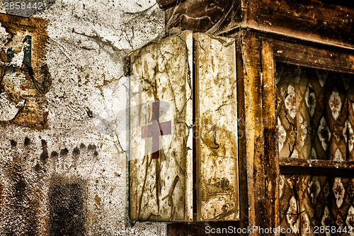 Image of Old first aid kit among the cobwebs